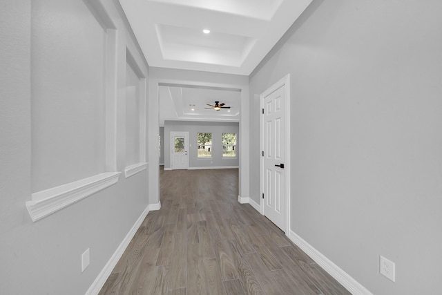 2506 Myrtle St, Waller, TX 77484 - hall featuring a raised ceiling, wood finished floors, and baseboards