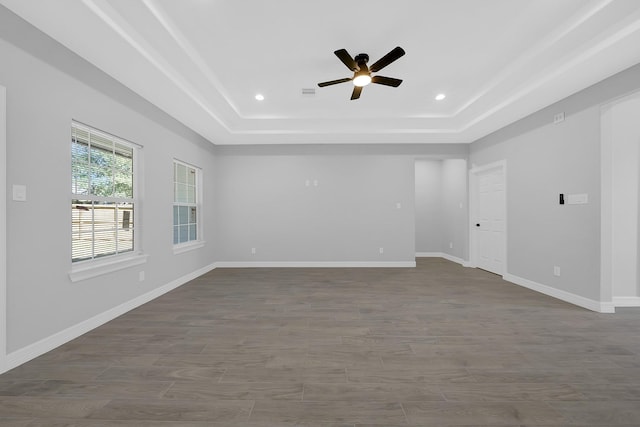 2506 Myrtle St, Waller, TX 77484 - spare room with a tray ceiling, ceiling fan, baseboards, recessed lighting, and dark wood finished floors