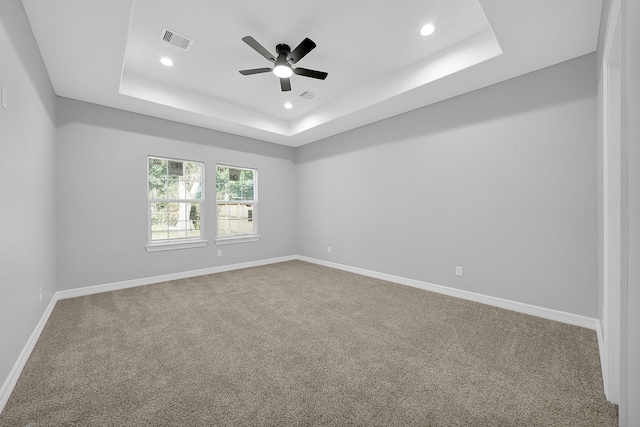 2506 Myrtle St, Waller, TX 77484 - empty room featuring a tray ceiling, carpet flooring, recessed lighting, ceiling fan, and baseboards