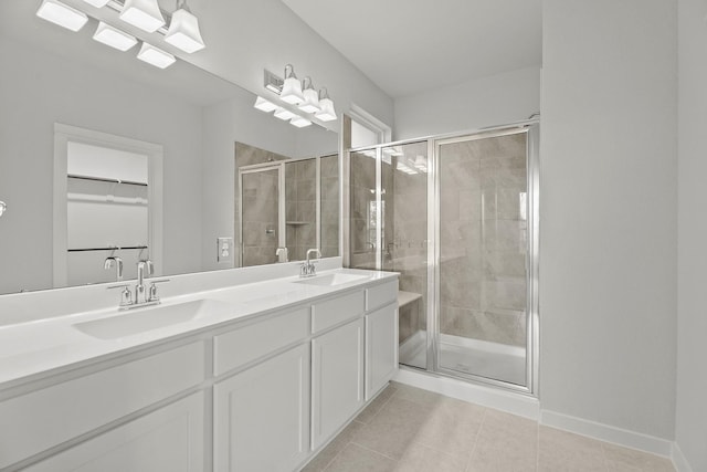 13122 Leisure Cove Dr, Texas City, TX 77568 - bathroom with a shower stall, tile patterned flooring, double vanity, and a spacious closet