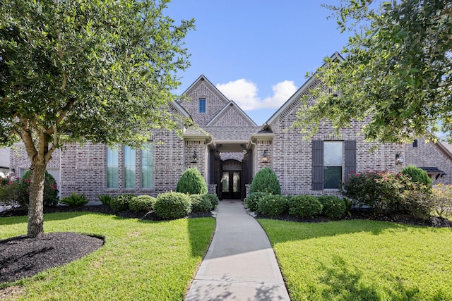 13630 E Palomino Lake Cir, Cypress, TX 77429 - view of front of house featuring brick siding, a front yard, and french doors