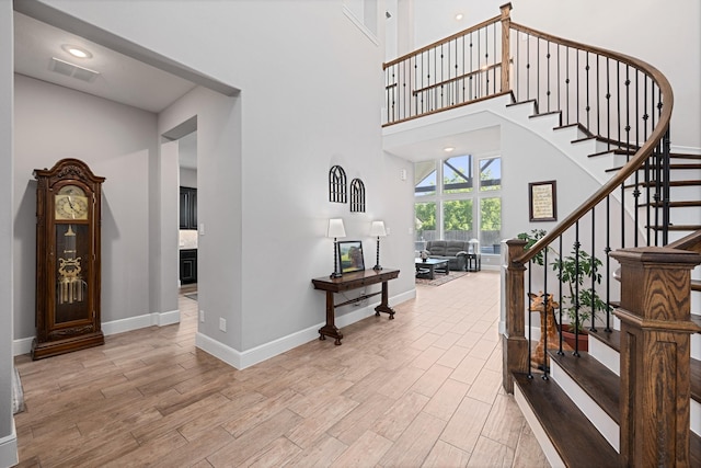 13630 E Palomino Lake Cir, Cypress, TX 77429 - entrance foyer with wood finished floors, stairway, baseboards, and a high ceiling