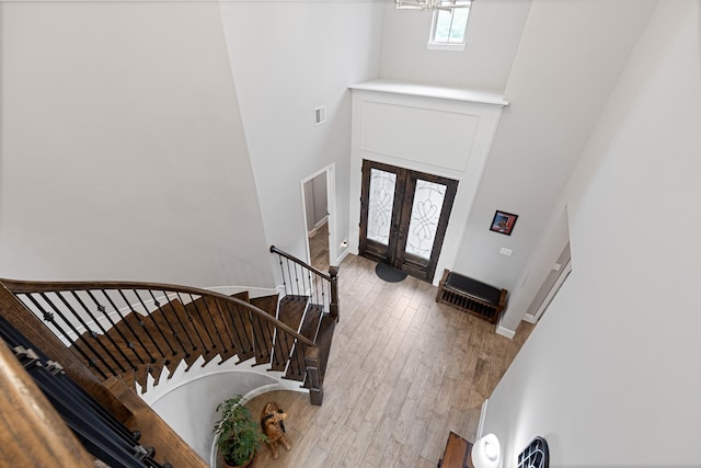 13630 E Palomino Lake Cir, Cypress, TX 77429 - entryway featuring a high ceiling, stairs, french doors, and wood finished floors