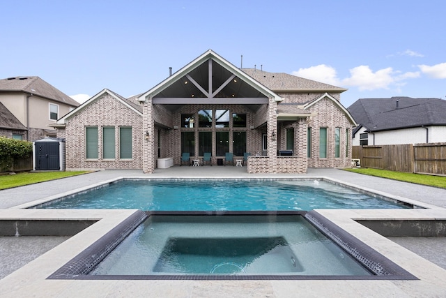 13630 E Palomino Lake Cir, Cypress, TX 77429 - view of swimming pool featuring a patio area, a storage shed, and a pool with connected hot tub
