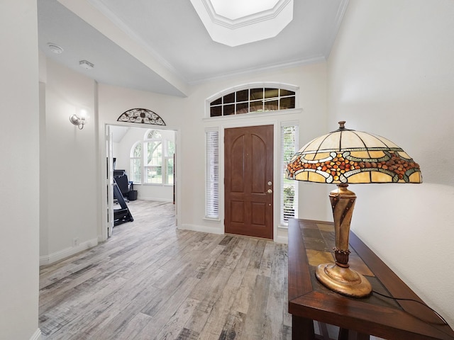 24602 Windemere Park Ct, Katy, TX 77494 - entryway with light wood-style floors, crown molding, a skylight, and baseboards