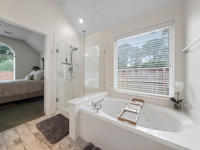 24602 Windemere Park Ct, Katy, TX 77494 - ensuite bathroom with vaulted ceiling, a stall shower, a whirlpool tub, and wood finished floors
