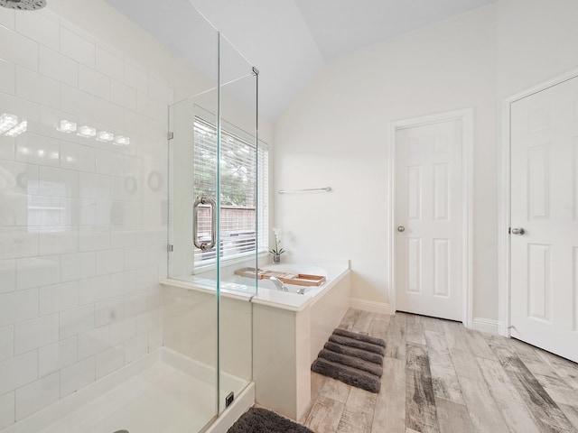24602 Windemere Park Ct, Katy, TX 77494 - full bathroom with a stall shower, a bath, lofted ceiling, wood finished floors, and baseboards
