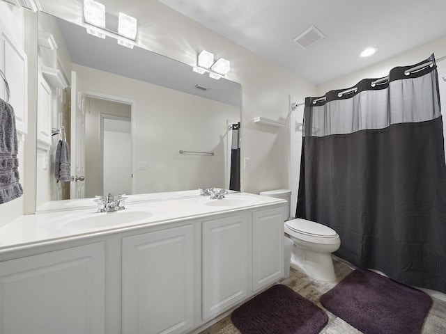 24602 Windemere Park Ct, Katy, TX 77494 - full bathroom with toilet, double vanity, a shower with shower curtain, and wood finished floors