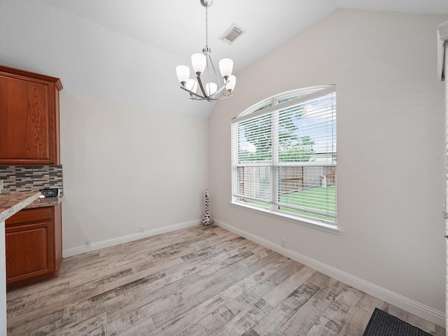 24602 Windemere Park Ct, Katy, TX 77494 - unfurnished dining area featuring vaulted ceiling, light wood-style flooring, a chandelier, and baseboards