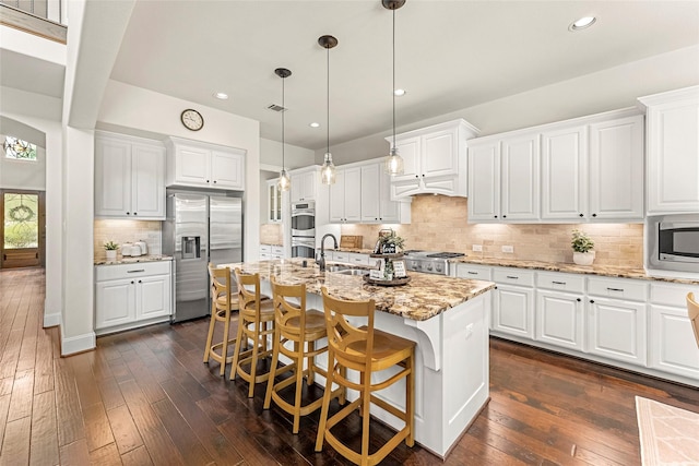 119 W Valera Ridge Pl, Spring, TX 77389 - kitchen featuring appliances with stainless steel finishes, a sink, tasteful backsplash, dark wood finished floors, and recessed lighting