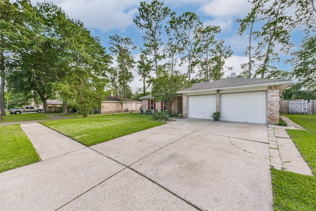 23011 Grand Rapids Ln, Spring, TX 77373 - view of front of house with brick siding, driveway, and an attached garage