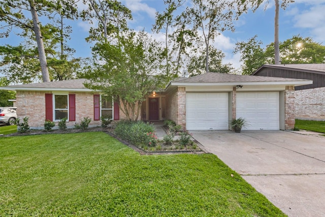 23011 Grand Rapids Ln, Spring, TX 77373 - view of front of home with a garage, concrete driveway, a front yard, and brick siding