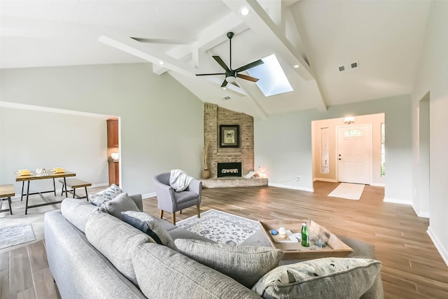 23011 Grand Rapids Ln, Spring, TX 77373 - living room with a ceiling fan, beamed ceiling, a skylight, wood finished floors, and recessed lighting