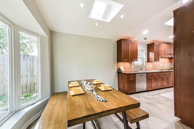 23011 Grand Rapids Ln, Spring, TX 77373 - dining space featuring a skylight, plenty of natural light, lofted ceiling, and recessed lighting