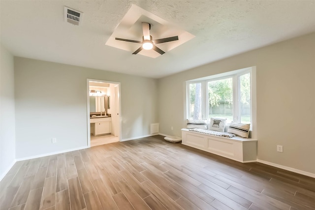 23011 Grand Rapids Ln, Spring, TX 77373 - unfurnished bedroom with wood finished floors, baseboards, ensuite bathroom, and ceiling fan