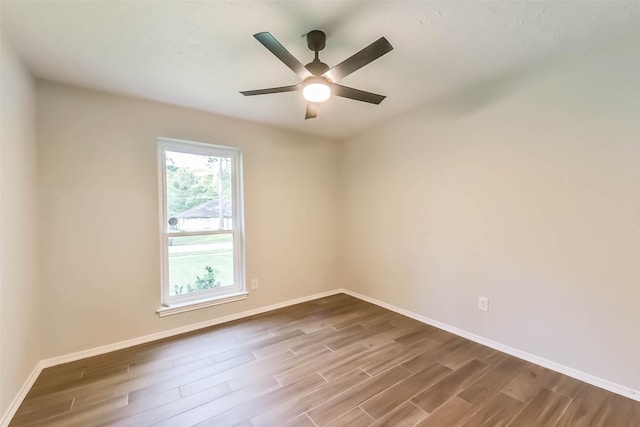 23011 Grand Rapids Ln, Spring, TX 77373 - empty room with dark wood-style flooring, baseboards, and a ceiling fan