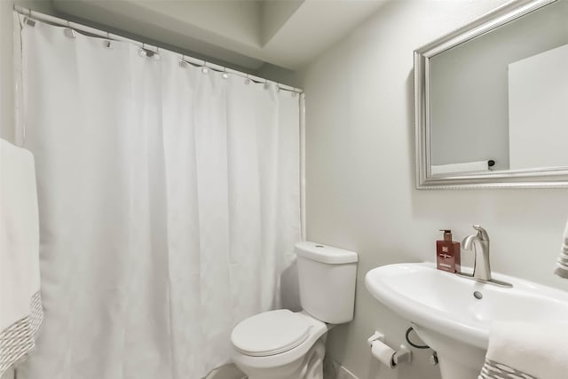 23011 Grand Rapids Ln, Spring, TX 77373 - bathroom with toilet, a sink, and a shower with shower curtain