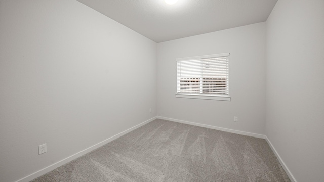 2405 Village Azalea Dr, Texas City, TX 77568 - spare room featuring carpet floors and baseboards