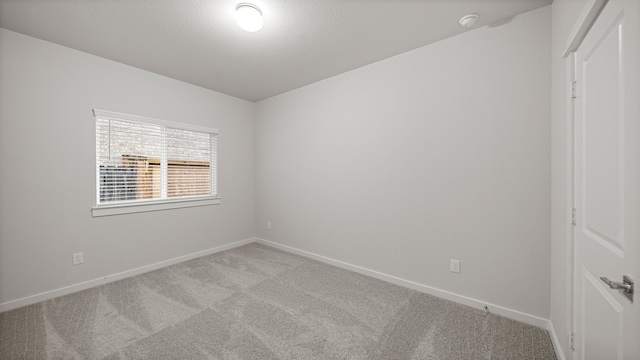 2405 Village Azalea Dr, Texas City, TX 77568 - spare room with light carpet, baseboards, and a smoke detector