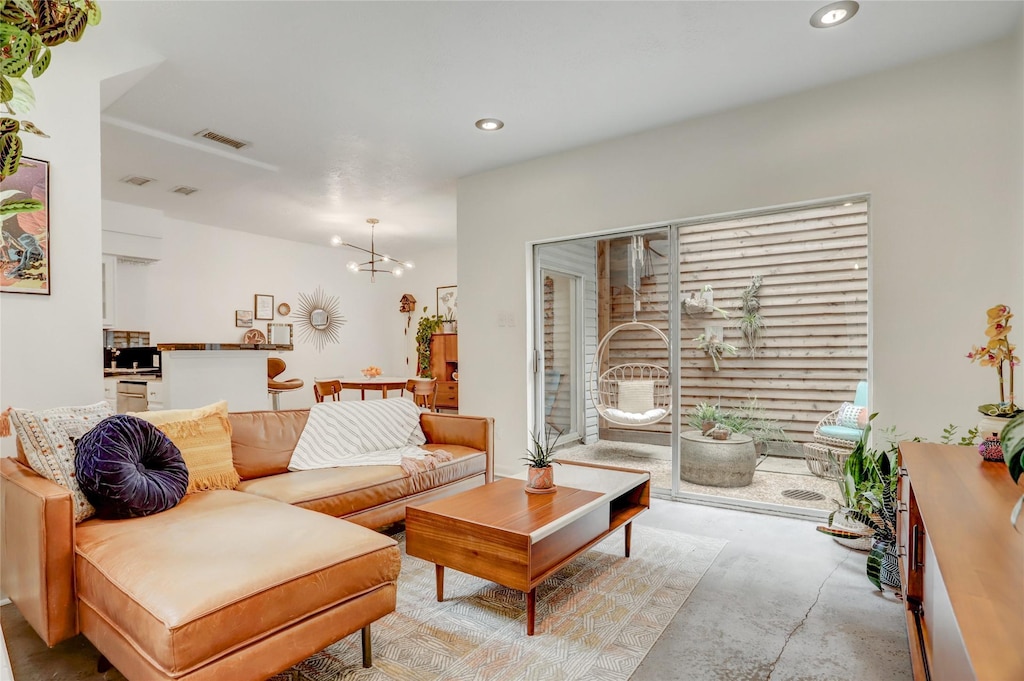 3336 Whitney St, Houston, TX 77006 - living area with a chandelier, recessed lighting, and concrete flooring