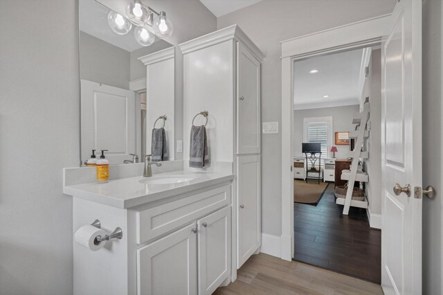 9 Broad St, Galveston, TX 77554 - bathroom featuring wood finished floors, vanity, baseboards, and recessed lighting