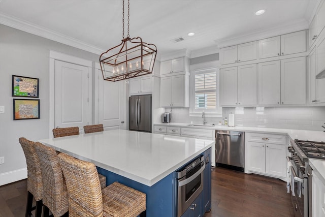 9 Broad St, Galveston, TX 77554 - kitchen with stainless steel appliances, a sink, a chandelier, recessed lighting, and crown molding