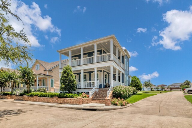 9 Broad St, Galveston, TX 77554 - view of front of house featuring a balcony, covered porch, and stairs