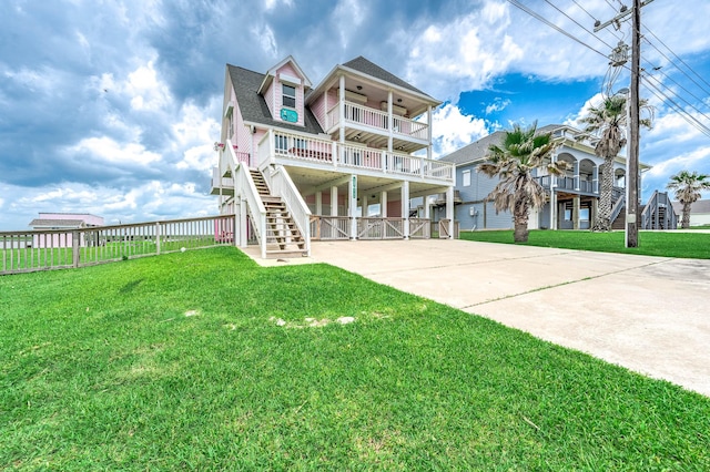 1197 County Road 230, Sargent, TX 77414 - view of front of property featuring stairs, a balcony, ceiling fan, and driveway