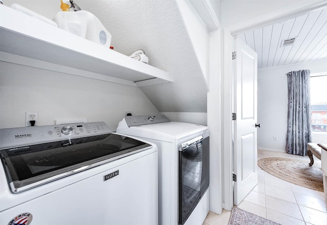 1197 County Road 230, Sargent, TX 77414 - laundry area with independent washer and dryer and light tile patterned flooring
