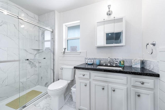 1197 County Road 230, Sargent, TX 77414 - bathroom featuring marble look tile flooring, toilet, vanity, and a marble finish shower