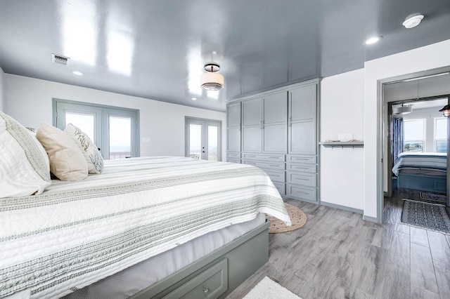1197 County Road 230, Sargent, TX 77414 - bedroom featuring french doors, light wood-style flooring, recessed lighting, a closet, and baseboards