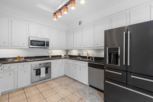 1518 S Gessner Rd, Houston, TX 77063 - kitchen featuring stainless steel appliances, a sink, dark countertops, and white cabinetry