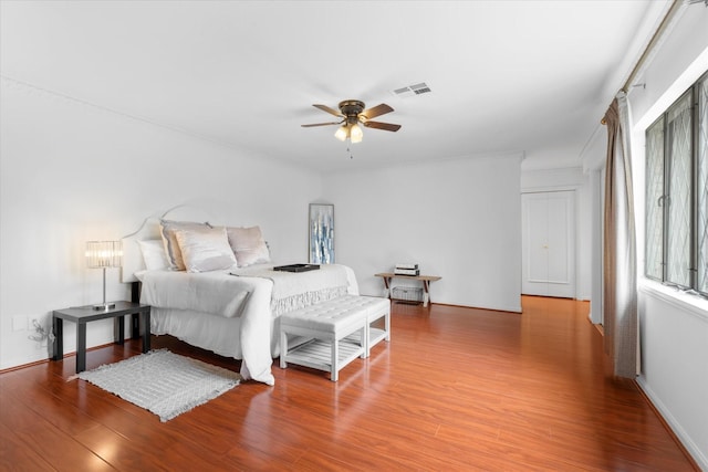 1518 S Gessner Rd, Houston, TX 77063 - bedroom featuring wood finished floors, a ceiling fan, and baseboards