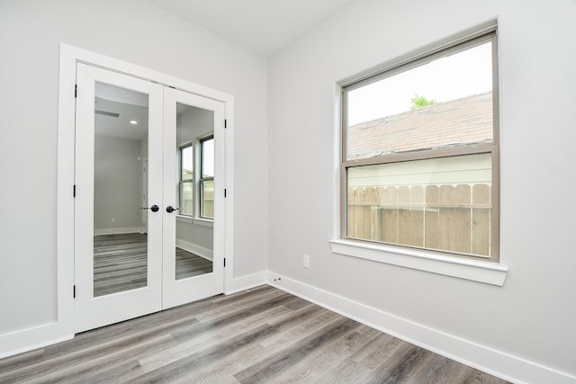 3337 Shelby Cir, Houston, TX 77051 - empty room with french doors, wood finished floors, and baseboards