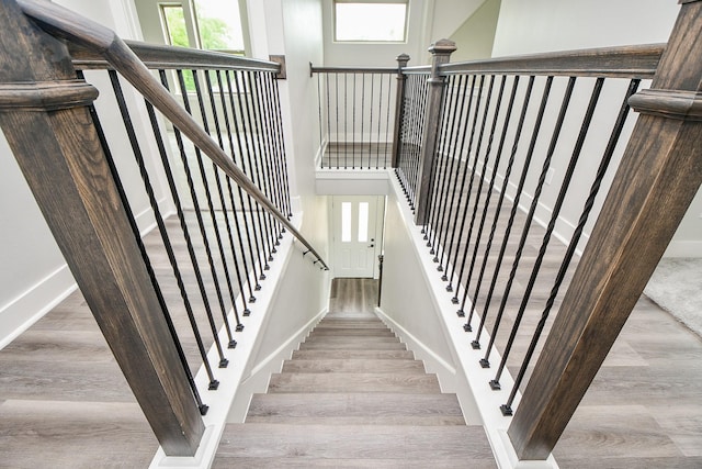 3337 Shelby Cir, Houston, TX 77051 - staircase with plenty of natural light, wood finished floors, baseboards, and a high ceiling