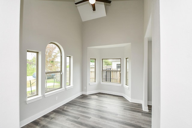 3337 Shelby Cir, Houston, TX 77051 - empty room featuring a towering ceiling, a ceiling fan, dark wood-style flooring, and baseboards