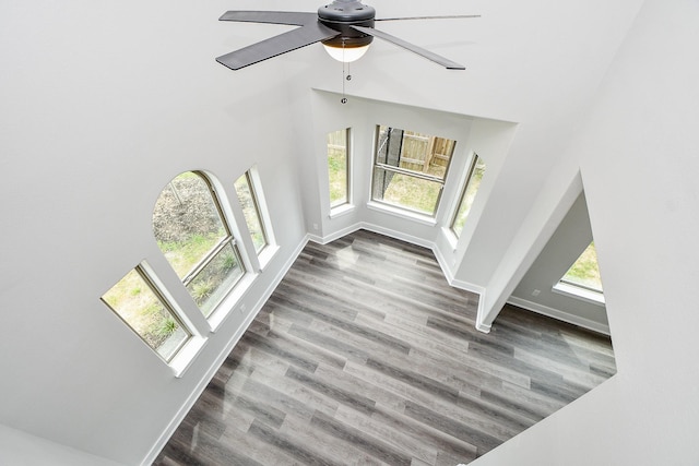 3337 Shelby Cir, Houston, TX 77051 - unfurnished living room featuring a towering ceiling, wood finished floors, ceiling fan, and baseboards
