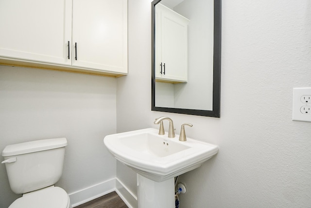 3337 Shelby Cir, Houston, TX 77051 - half bath featuring baseboards, toilet, wood finished floors, and a sink