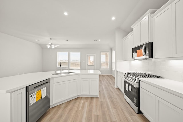 319 Riesling Dr, Alvin, TX 77511 - kitchen featuring stainless steel appliances, a sink, decorative backsplash, recessed lighting, and light countertops