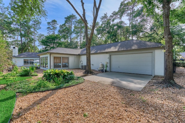 23106 Hampton Forest Ln, Spring, TX 77389 - ranch-style house featuring a garage, driveway, central AC unit, and stucco siding