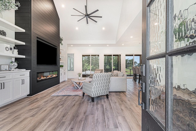 111 Seagull Path, Point Blank, TX 77364 - living area with a fireplace, light wood-type flooring, recessed lighting, ceiling fan, and a towering ceiling