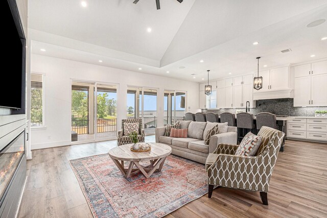 111 Seagull Path, Point Blank, TX 77364 - living area featuring recessed lighting, light wood-style flooring, plenty of natural light, high vaulted ceiling, and a glass covered fireplace