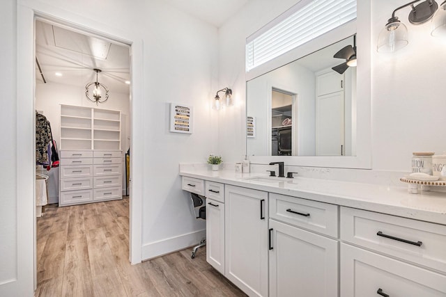 111 Seagull Path, Point Blank, TX 77364 - bathroom with a spacious closet, vanity, and wood finished floors