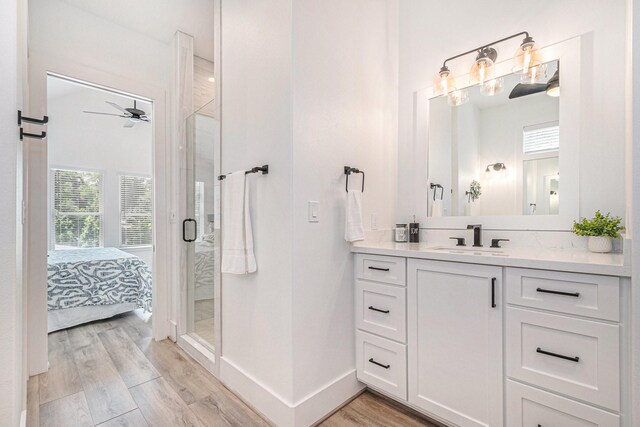 111 Seagull Path, Point Blank, TX 77364 - bathroom with vanity, a stall shower, wood finished floors, ensuite bath, and a ceiling fan