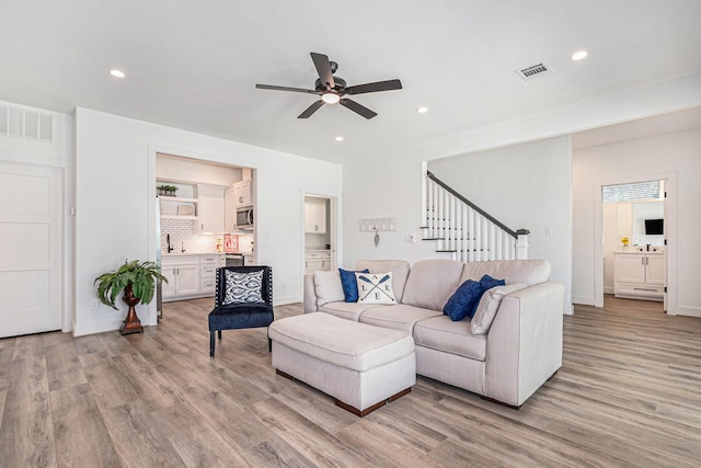111 Seagull Path, Point Blank, TX 77364 - living area featuring light wood finished floors, ceiling fan, stairway, and recessed lighting