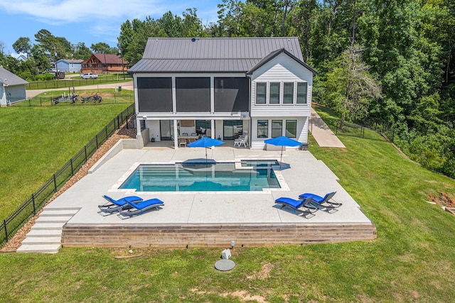 111 Seagull Path, Point Blank, TX 77364 - back of property with a sunroom, a patio area, a fenced backyard, a standing seam roof, and a metal roof