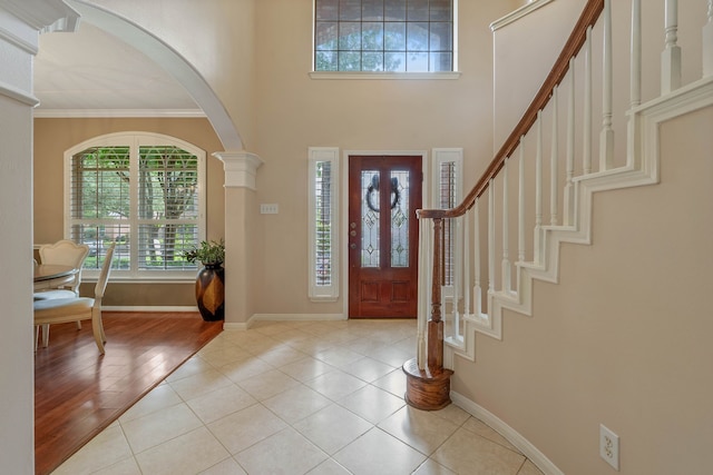 31335 Bearing Star Ln, Tomball, TX 77375 - tiled entryway with healthy amount of natural light, ornamental molding, arched walkways, a towering ceiling, and stairs