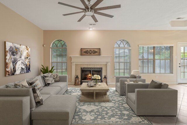 31335 Bearing Star Ln, Tomball, TX 77375 - living room featuring ceiling fan, a tile fireplace, and light tile patterned flooring