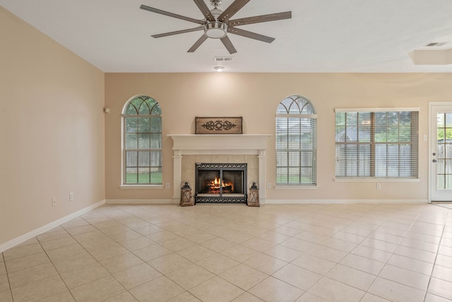 31335 Bearing Star Ln, Tomball, TX 77375 - unfurnished living room with a tiled fireplace, a ceiling fan, and light tile patterned floors