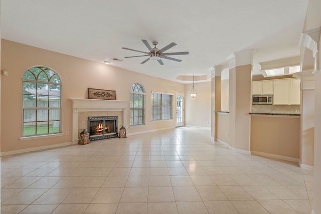 31335 Bearing Star Ln, Tomball, TX 77375 - unfurnished living room featuring ceiling fan, light tile patterned floors, and a fireplace